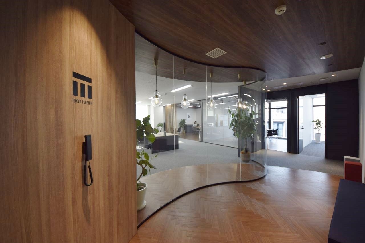 オフィスデザイン実績 						Rガラスの美しい曲線、木目とスケルトン天井の開放オフィス
